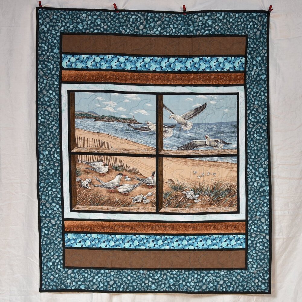 New handmade throw quilt, beautiful beach scene looking out window at seagulls